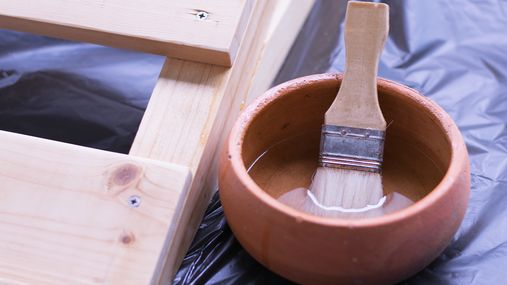 High-Quality Wood Coating Paints in Bahrain | Prisma Paints Prisma Paints Bahrain: Paint brush resting on a wood coating project in Manama.